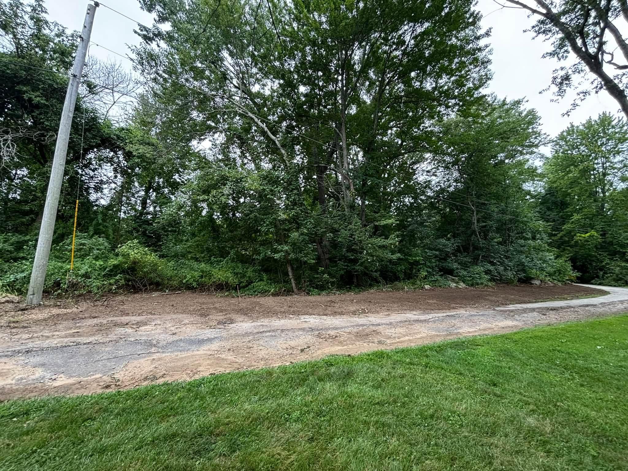 After loam and mulch on regraded slope, Spencer MA